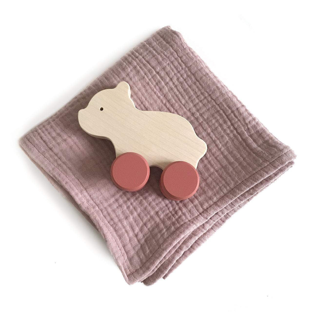 A beautiful set with handmade wooden bear with red wheels push toy. Also comes with a pink swaddle blanket. All wrapped up in a beautiful craft box.  