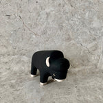 Load image into Gallery viewer, handmade and hand painted black wooden bison toy with white feet, ears and nose
