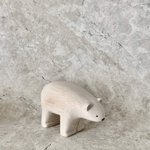 A beautifully hand crafted and painted white wooden polar bear with cute black eyes and nose. 